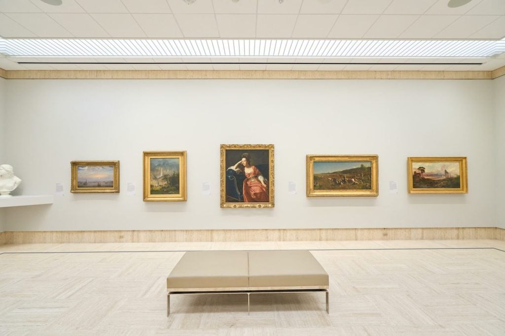 Interior of the Timken Museum of Art featuring a bright room with various historic art framed in gold on the walls in Balboa Park, San Diego