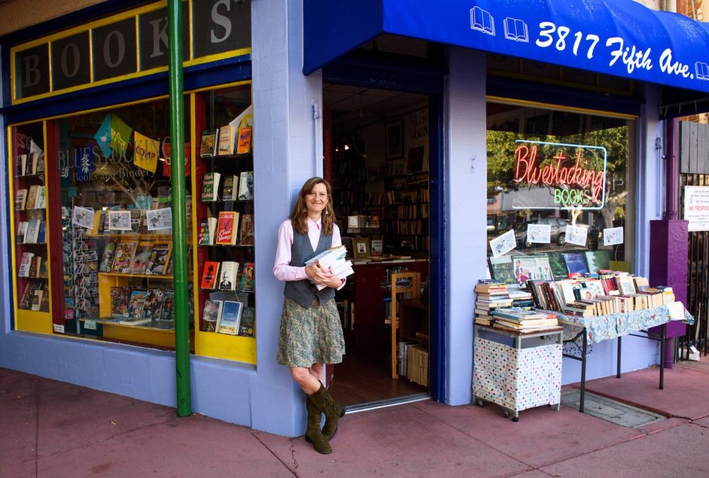 Exterior of San Diego bookstore Bluestocking Books in Hilcrest with the store's founder Kris Nelson