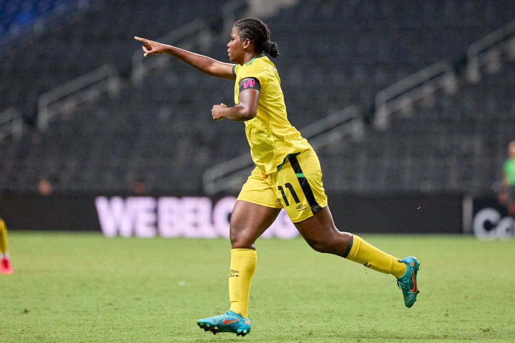 Jamaican soccer player in the 2024 Women's Concacaf Gold Cup match pointing at empty stands at Snapdragon Stadium in San Diego