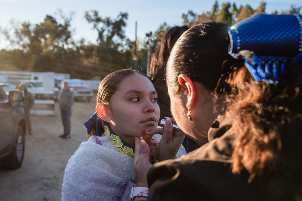 Members of the San Diego Escaramuza team Las Reynas del Sol’s putting lipstick on before a competition