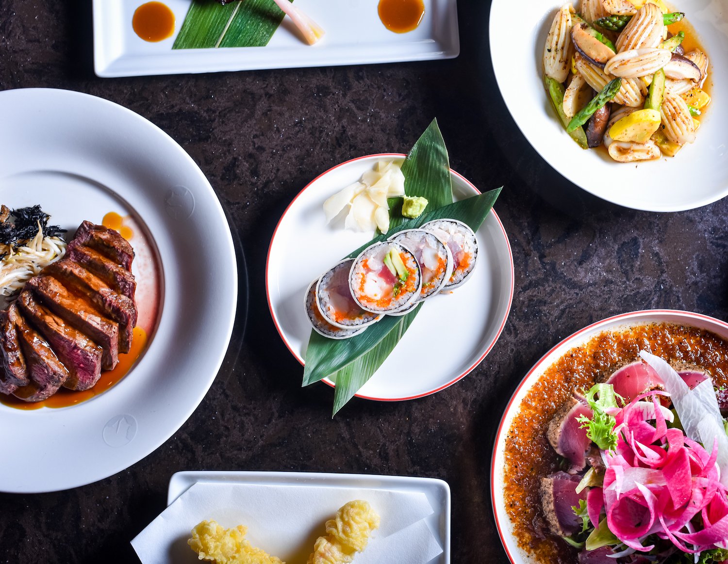 A table full of Nubu sushi, sashimi, and other Japanese food at the Hotel Del Coronado's new location