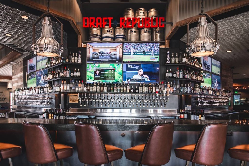 Draft Republic Carlsbad interior featuring their bar, beer taps, TV screens as part of their Super Sunday Special 