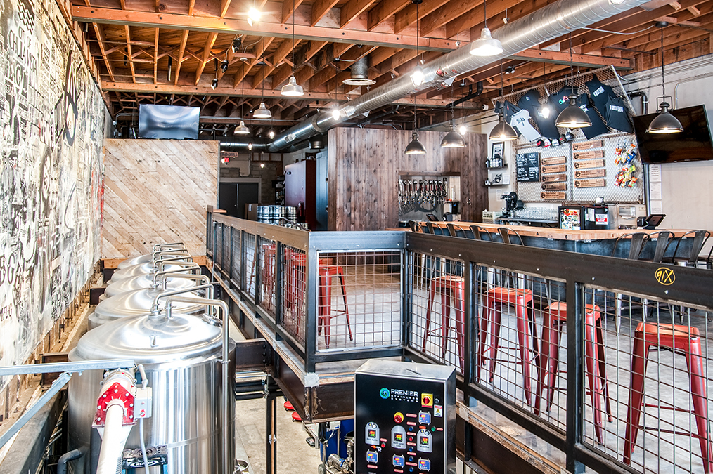 Interior of South Bay brewery Thre3 Punk Ales in Chula Vista, San Diego featuring beer casks, bar seating, and beer taps