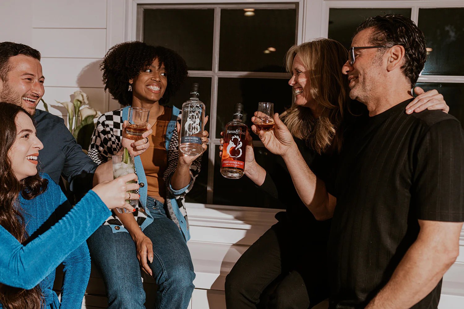Founders of San Diego company Fierce & Kind Spirits, Cyndi Smith and Basem Harb, sharing a drink of their bourbon and vodka with friends