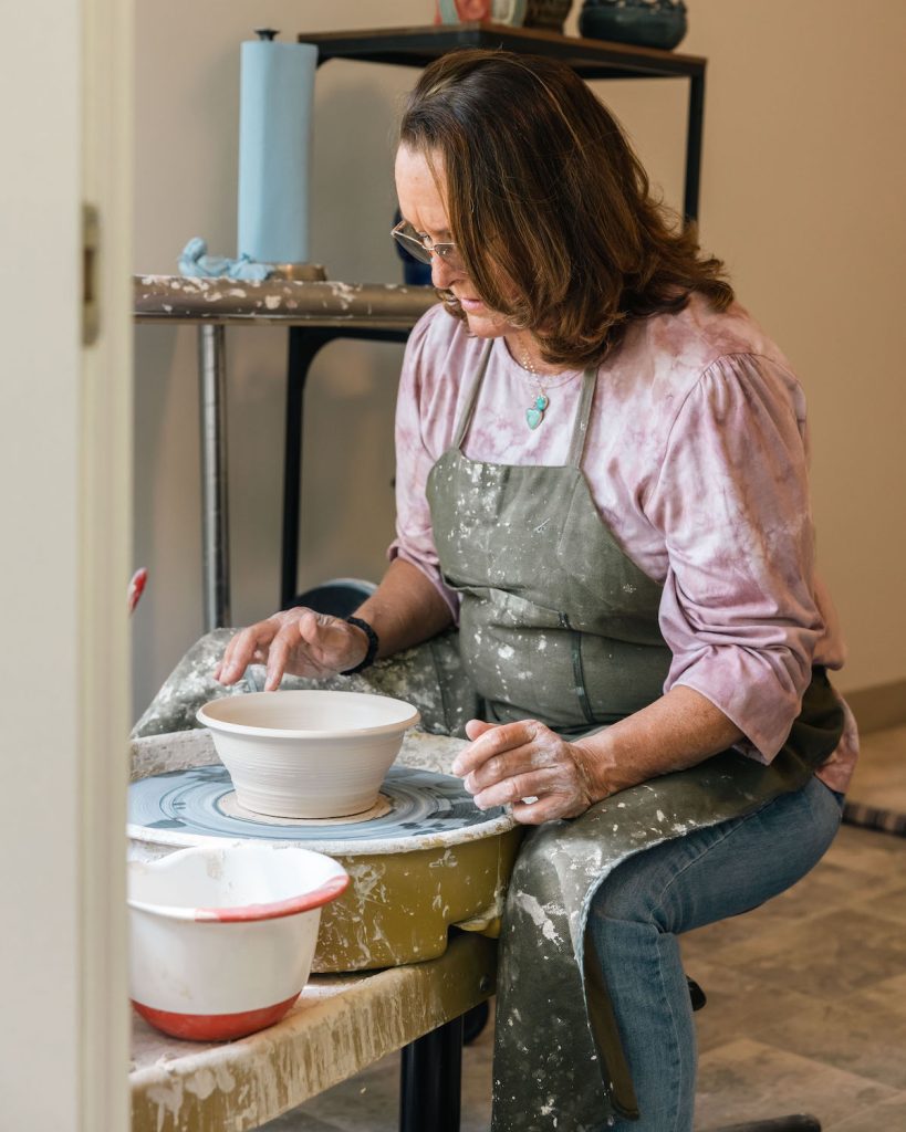 Marcia Johnson, founder of the OURS Art Foundation, a San Diego nonprofit focused on helping victims of trauma through art therapy, throwing a bowl on a pottery wheel