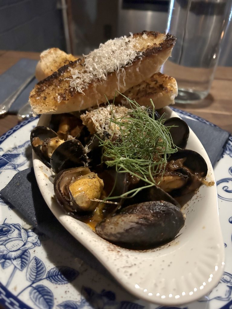 Mussels and bread on a plate from Mexican restaurant and wine bar Échale in Encinitas, San Diego