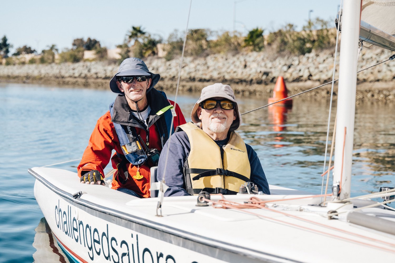 Two disabled men sailing together in the San Diego Bay with the Challenged Sailors San Diego organization