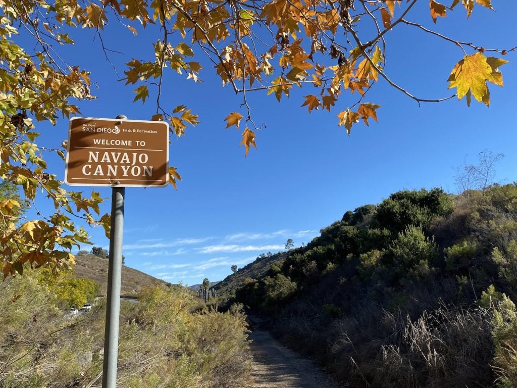 The Navajo Canyon Open Space trail located in Allied Gardens San Diego featuring a trail sign and a path through the valley