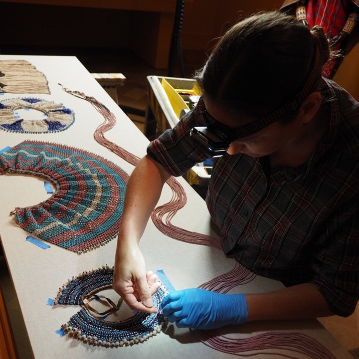 A worker builds a display for the Agents of Power: Body Adornment in African Art exhibit at the San Diego Museum of Art in 2024