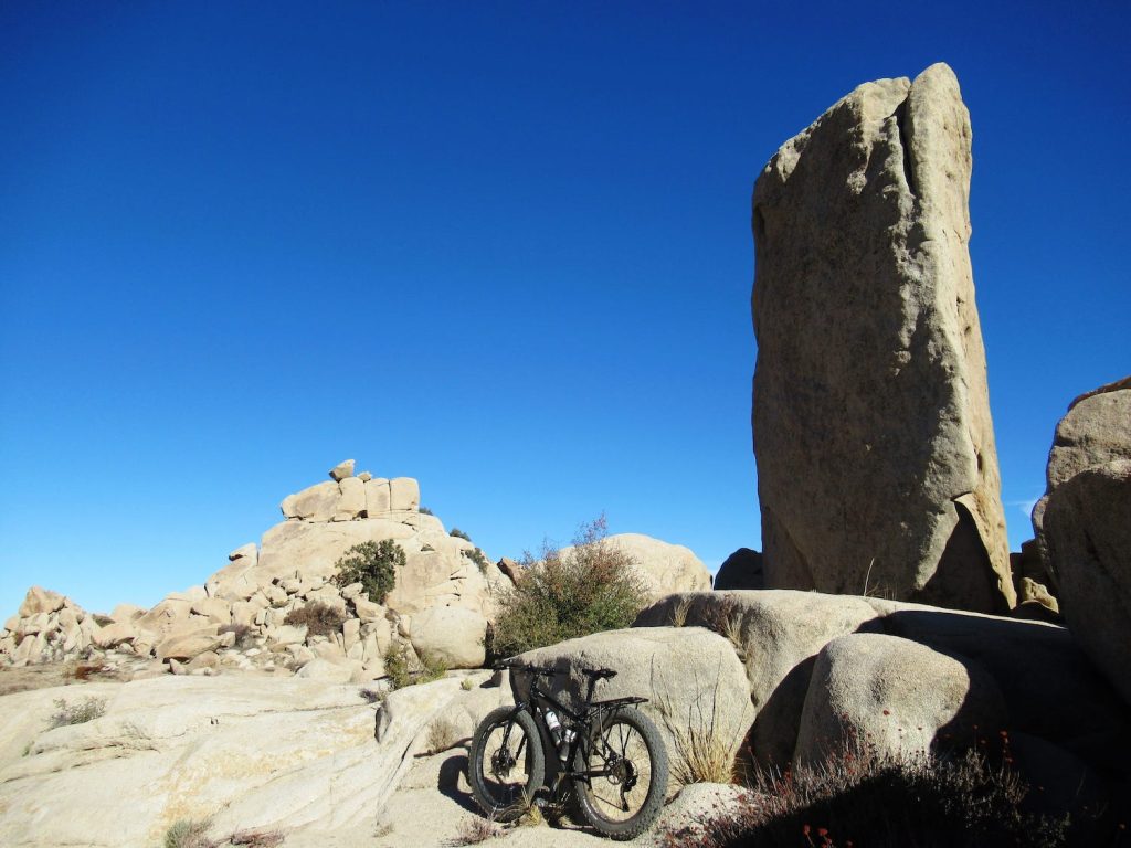 A mountain bike infront of a unique rock formation found at Valley of the Moon in the Anza Borrego Desert