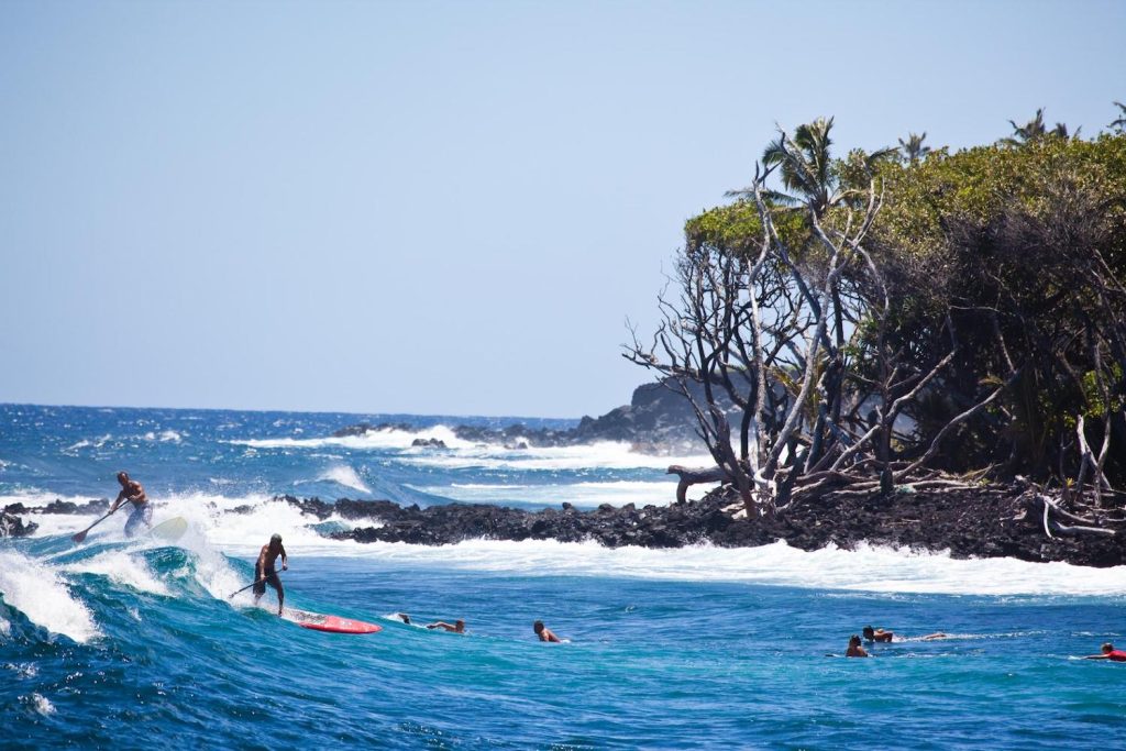 People surfing in the waves on the big island of Hawaii