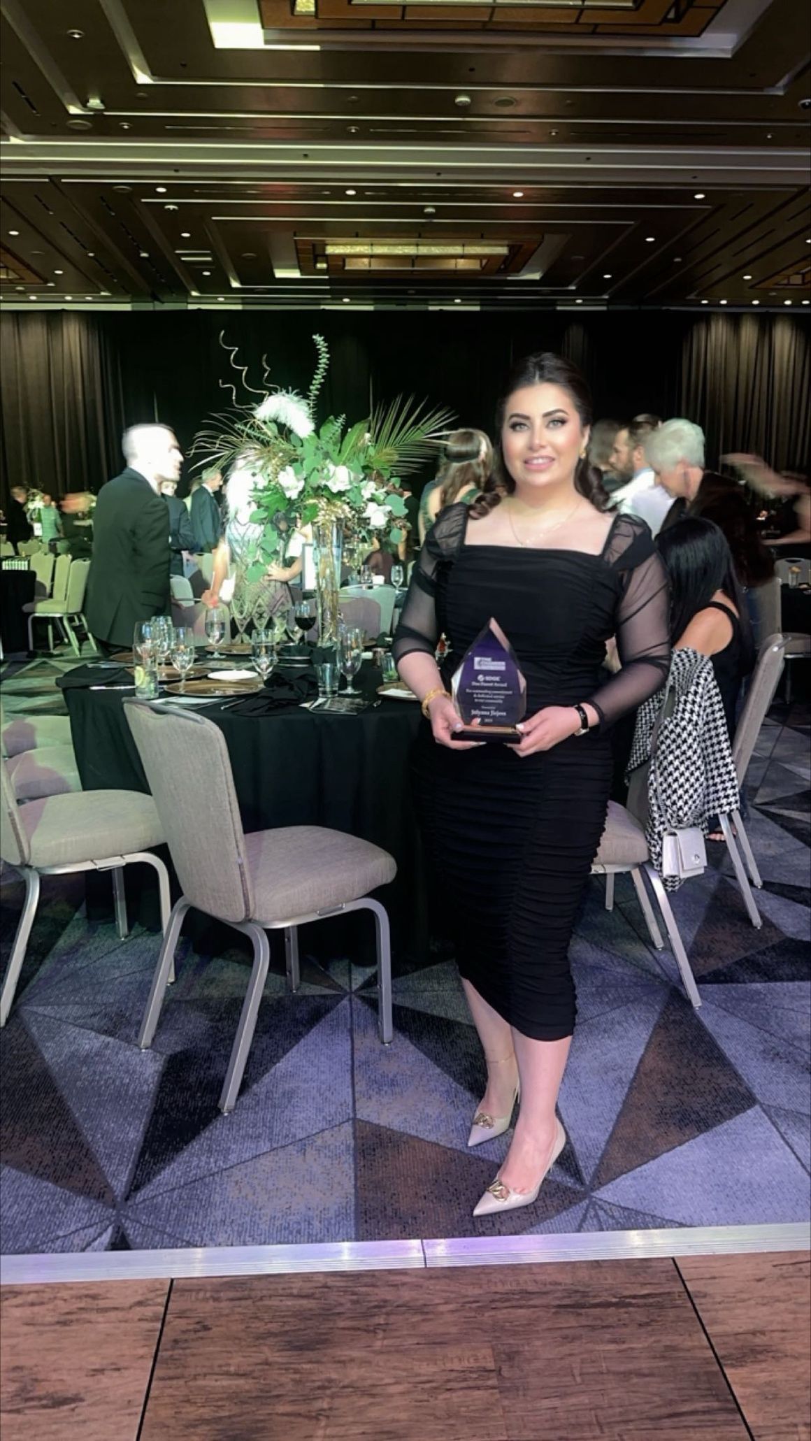 Jolyana Jirjees of San Diego organization Chaldean Community Council holding an award