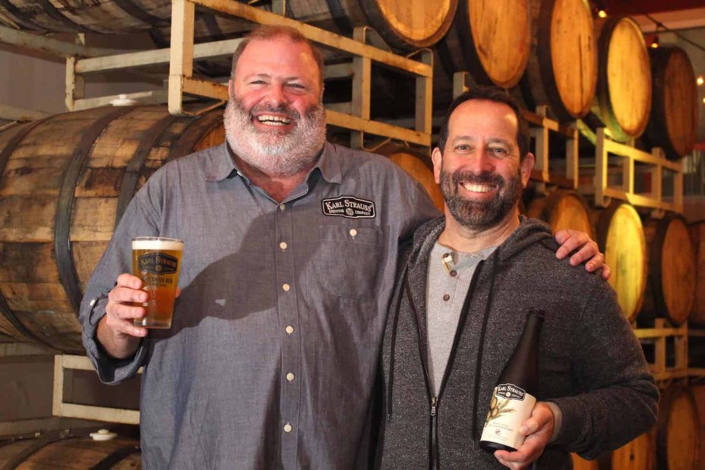 Founders of Karl Strauss Brewing company in their brewery celebrating their 35th anniversary