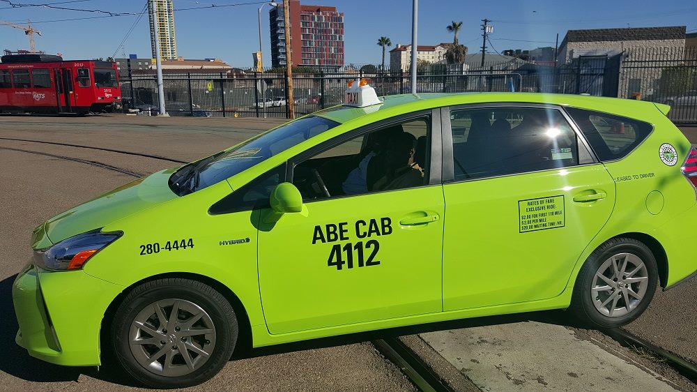 Green taxi cab driven by Jama Utwsd who founded the San Diego-based app United Ride
