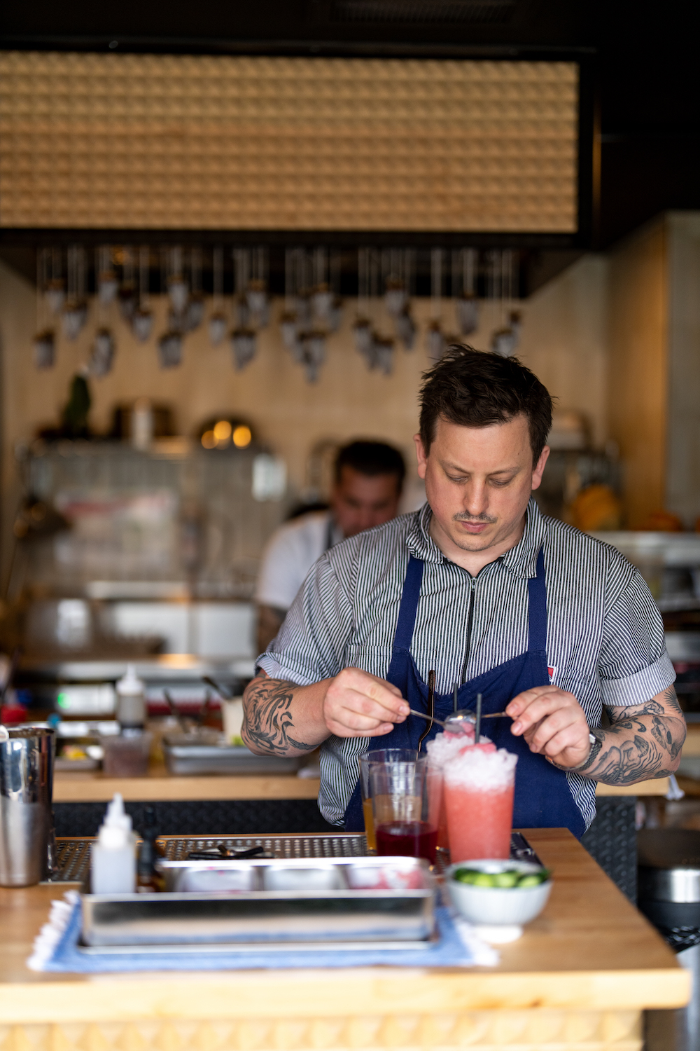 Bartender at Atelier Manna in Leucadia, San Diego making a non-alcoholic cocktail beverage 