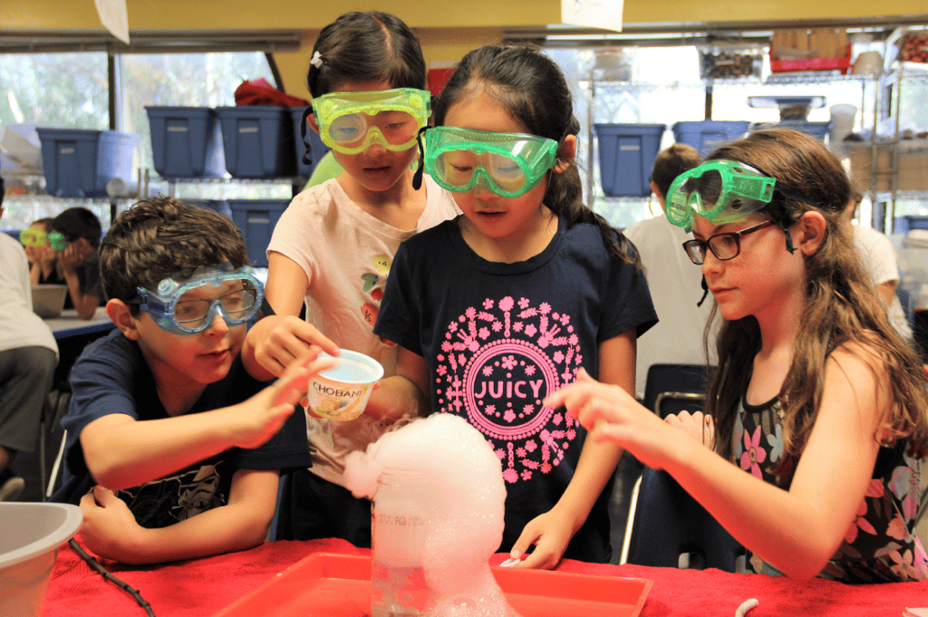 Kids engaging in a science experiment during summer camp at the Fleet Science Center at Balboa Park, San Diego