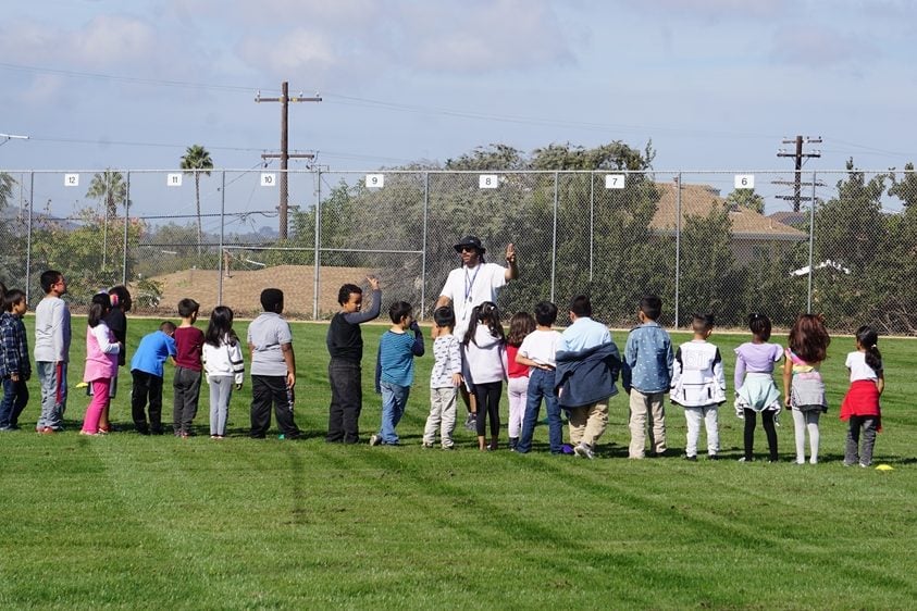 San Diego Unified Extended School Year summer camp with kids on a field with an instructor