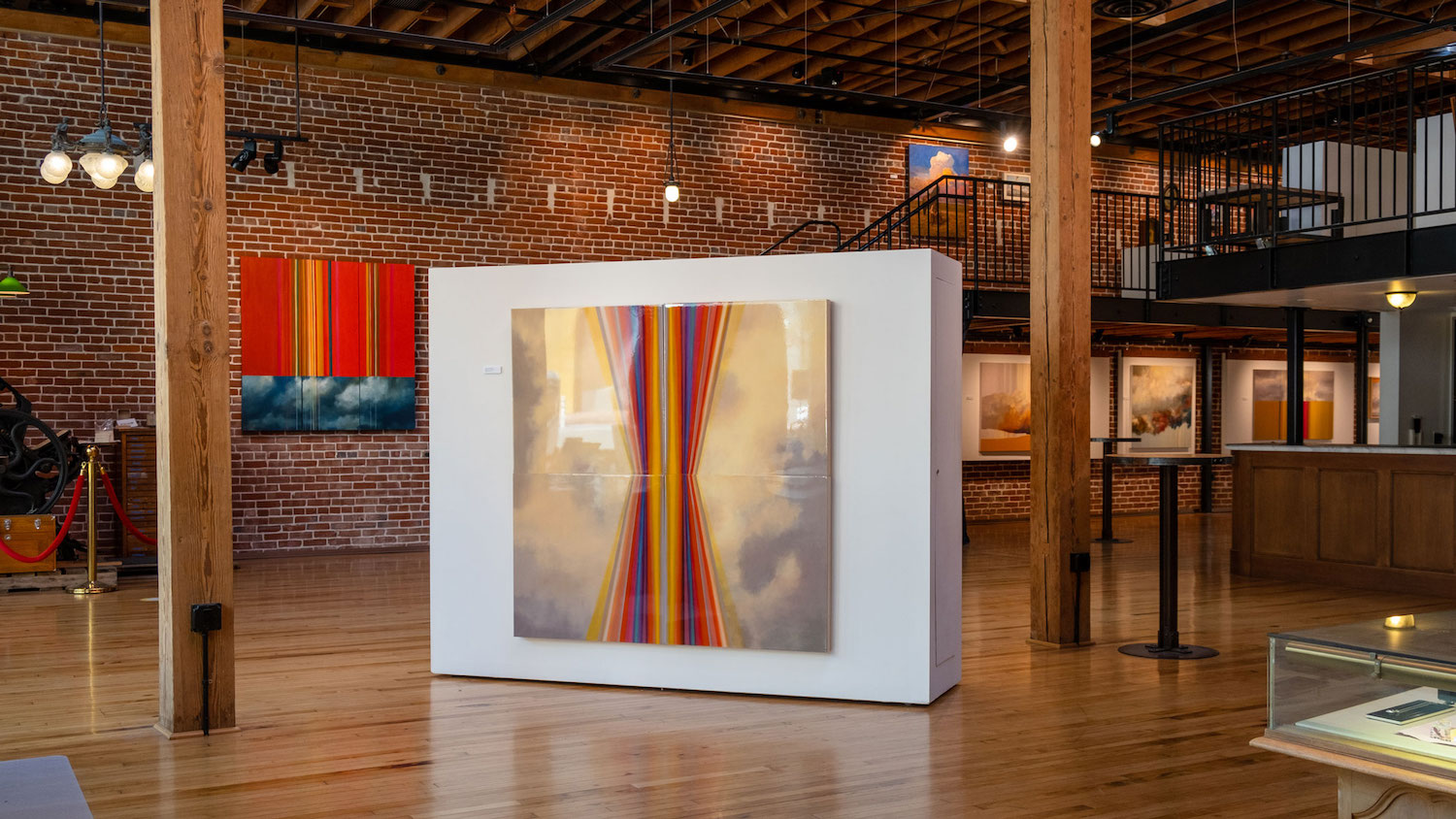 Interior of Sparks art gallery in the Gaslamp Quarter, San Diego featuring larger artwork in the middle of a brick room 
