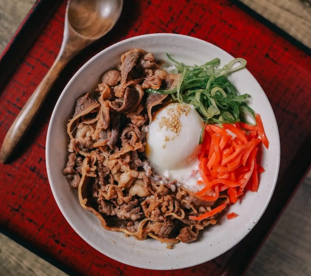 Michelin-Recognized Baikohken Ramen restaurant featuring a beef dish with egg in a bowl