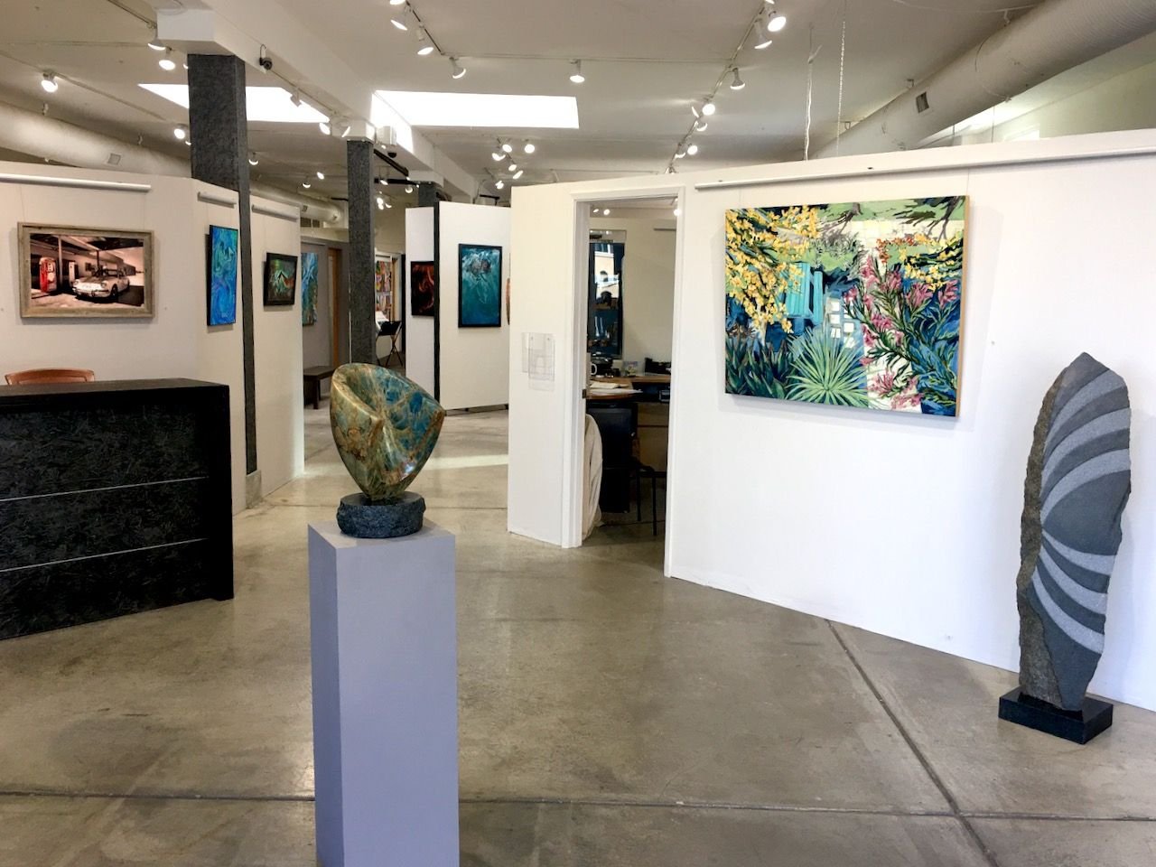 Interior of The Studio Door art gallery in Hillcrest, San Diego featuring sculptures and paintings 