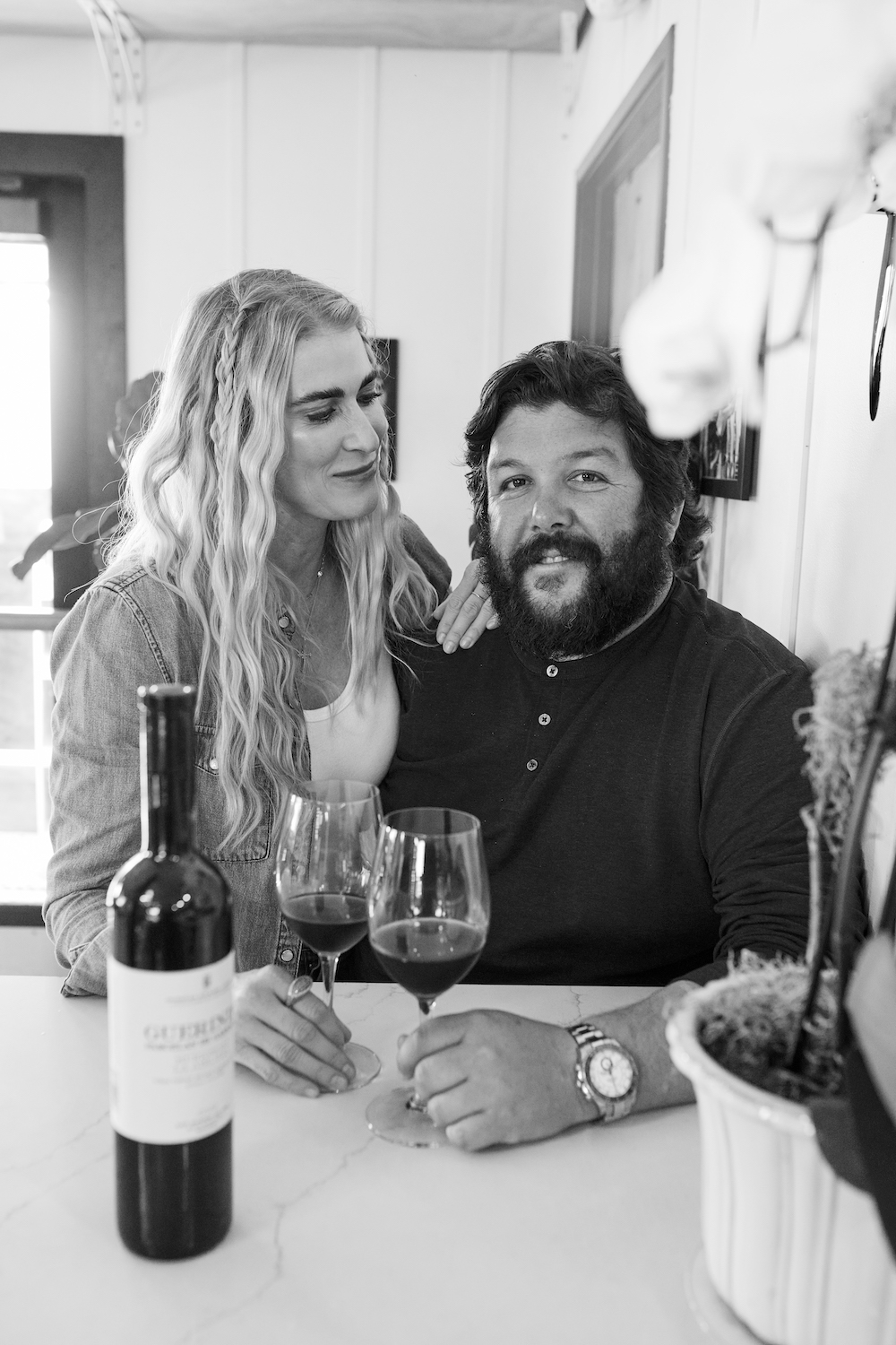 Husband and wife team Mario + Morgan Jean Guerra, that founded The Leucadia restaurant company, drinking glasses of wine