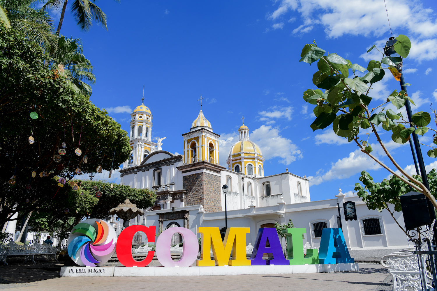 The town of Comala, Mexico featuring its iconic white-and-yellow chapel