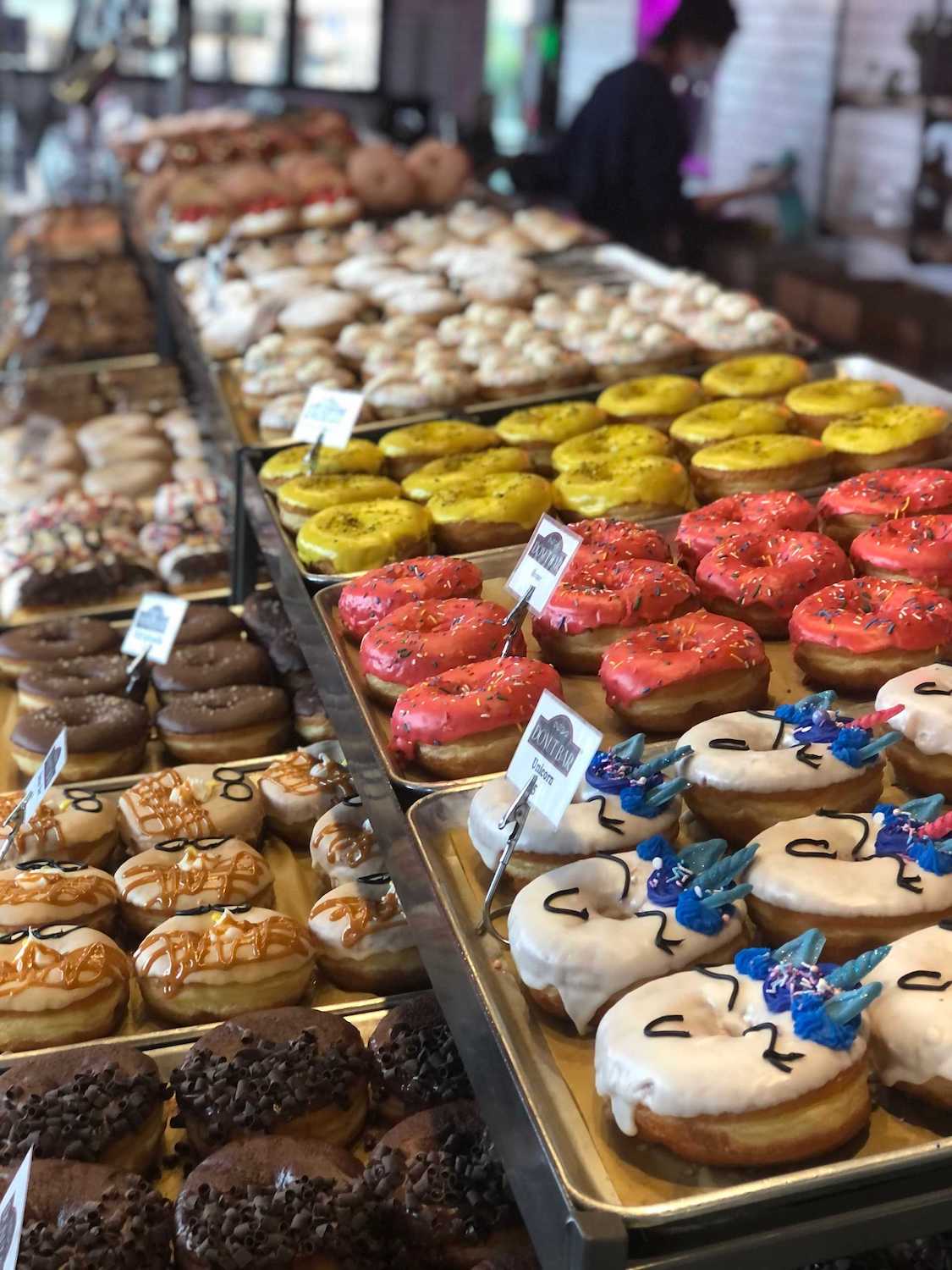 Donut Bar's new downtown San Diego location featuring an assortment of colorful, decorated donuts on display 