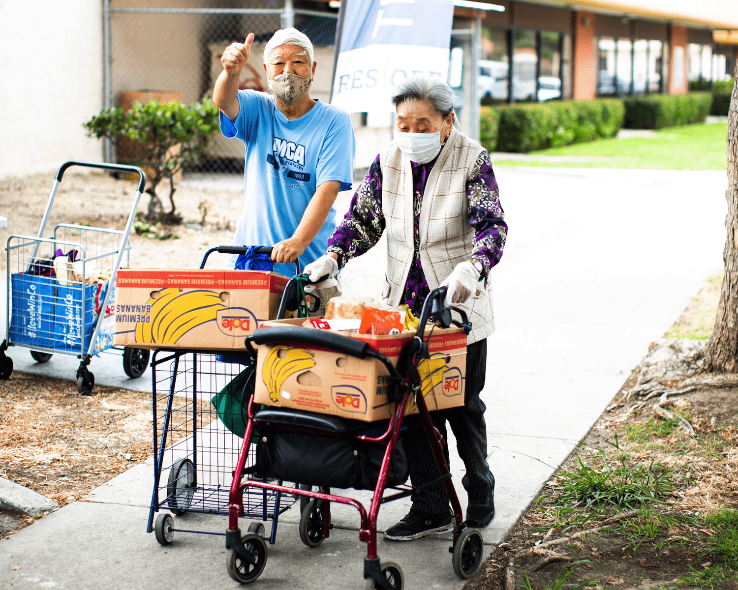 Elderly couple walking with donated food provided by San Diego nonprofit Feeding San Diego