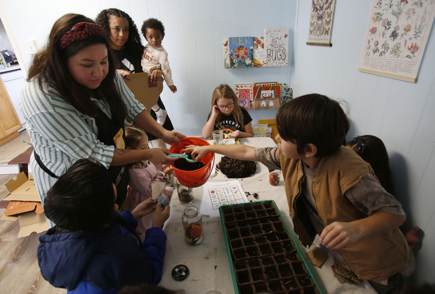 San Diego homeschool instructor helping kids learn about gardening and composting during 