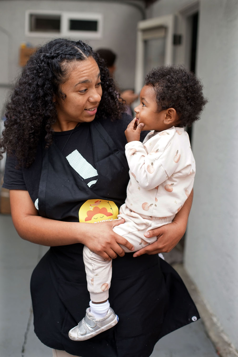 San Diego homeschool instructor Brianda Vargas has a chat with her daughter Lunita, 18 months, during the Flourish Homeschool co-op weekly gathering at a home in Clairemont. Several homeschooling families gather once or twice a week for community and shared lessons.