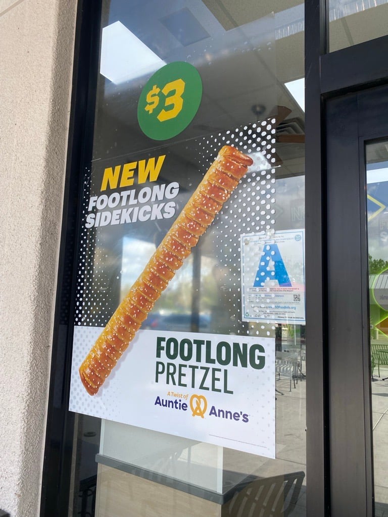 Subway's new Auntie Anne's footlong pretzel bread promo outside of a Subway restaurant in San Diego