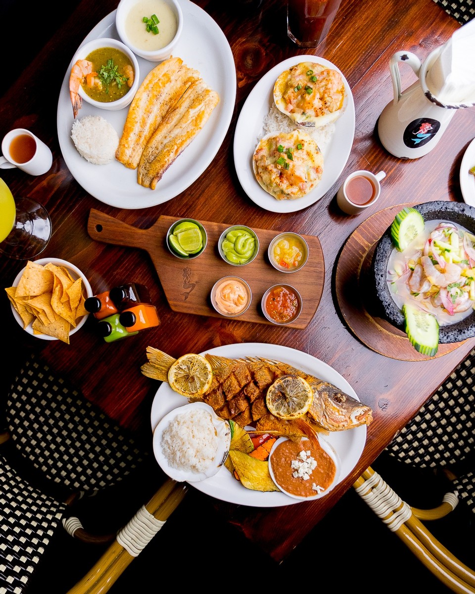 La Corriente Cocina del Pacifico Mexican seafood restaurant opening in La Jolla, San Diego in 2024 featuring a table full of seafood dishes and appetizers