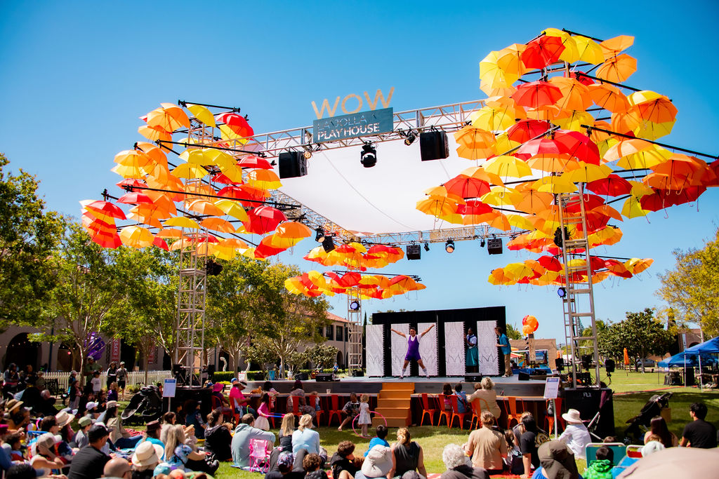 Without Walls (WOW) Festival event in San Diego this weekend April 4-7, 2024 featuring a stage with an umbrella art display