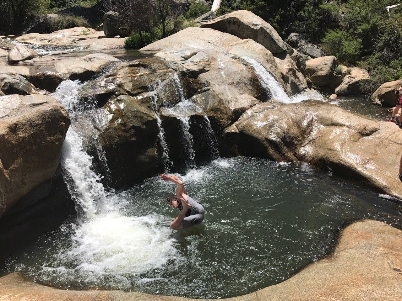 Person in swim trucks jumping into the Green Valley falls, a San Diego waterfall hike near Mount Laguna