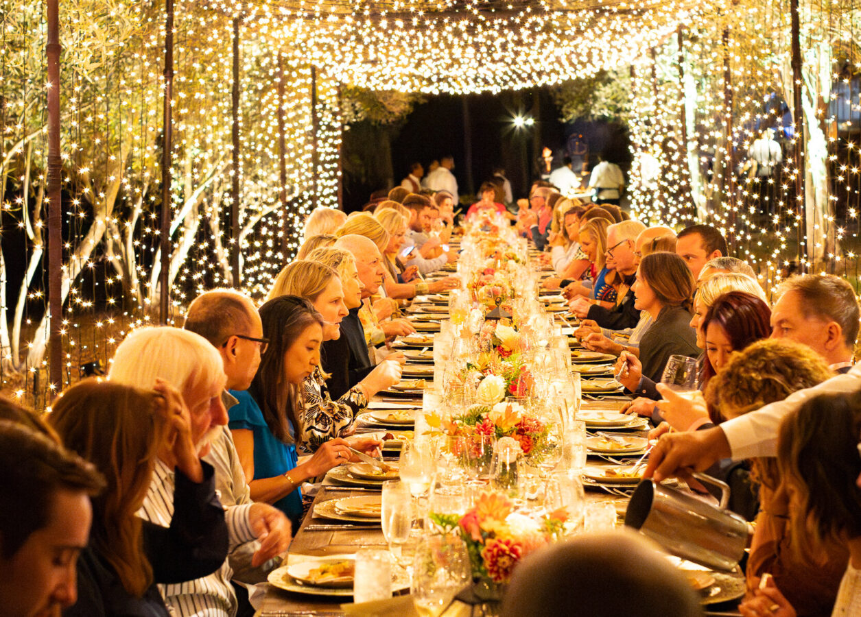 A table full of guests dining outside at Rancho Valencia's chef dinner hosted by Drew Deckman