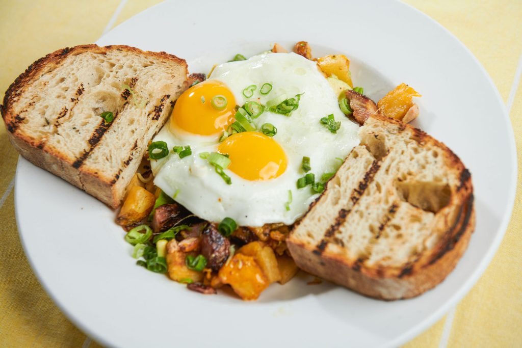Sunnyside up eggs with potatoes and toast from La Mesa Brunch Restaurant Toasted Gastrobrunch in San Diego 