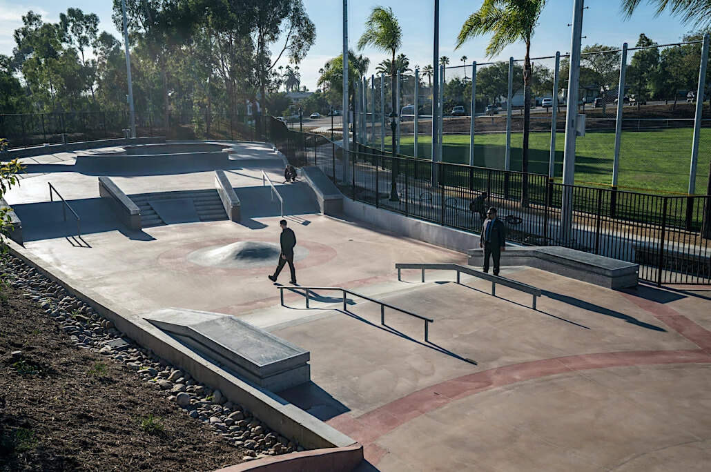 Park de la Cruz Skate Park in City Heights featuring a couple of skaters standing by rails