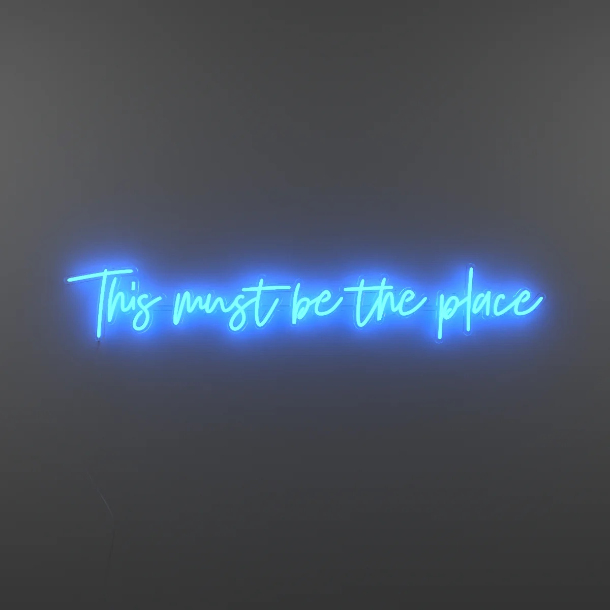 Neon light with text "This must be the place" in blue from Yellowpop