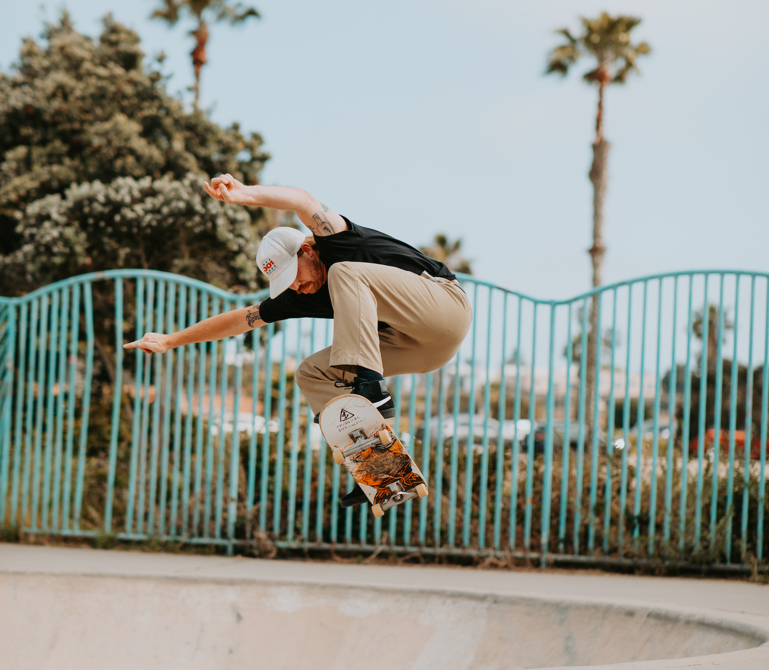 San Diego skater fashion featuring a skateboarder jumping into a bowl at Robb Field Skate Park, Ocean Beach
