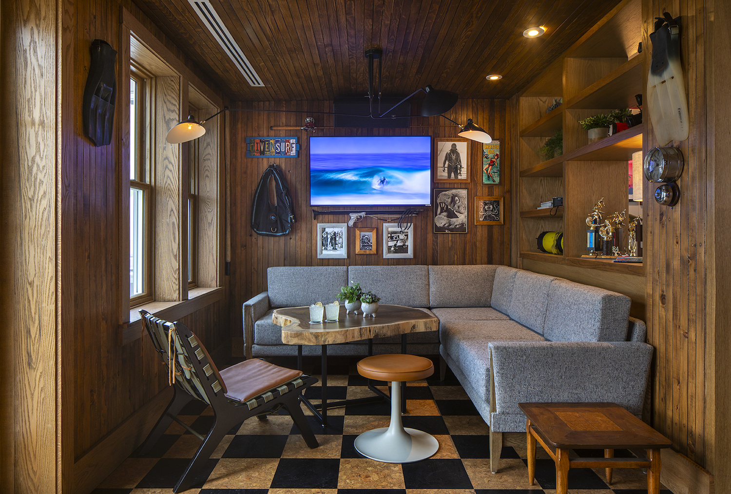 Interior of new San Diego restaurant and bar Hideaway Pacific Beach featuring a private room full of local surf memorabilia 