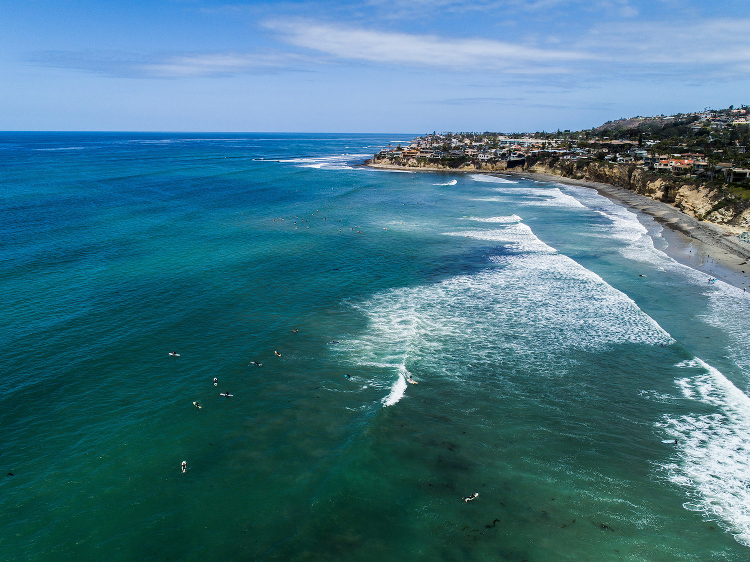 The best surf spots in San Diego featuring an aerial shot of Tourmaline and Old Man's in Pacific Beach