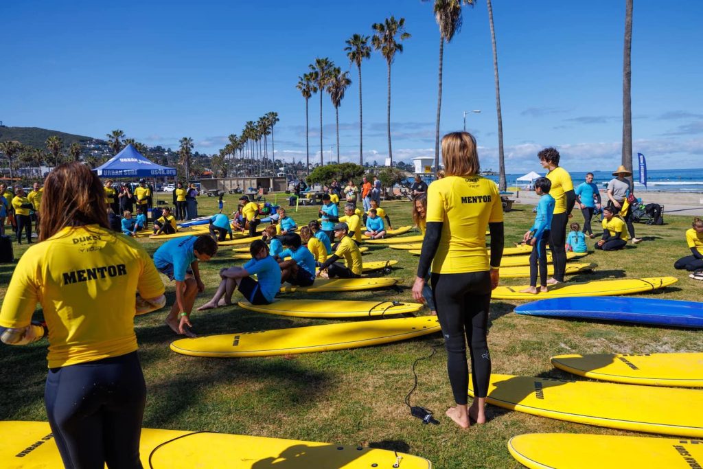 San Diego nonprofit Urban Surf 4 Kids featuring mentors and at-risk youth learning how to surf at La Jolla Shores