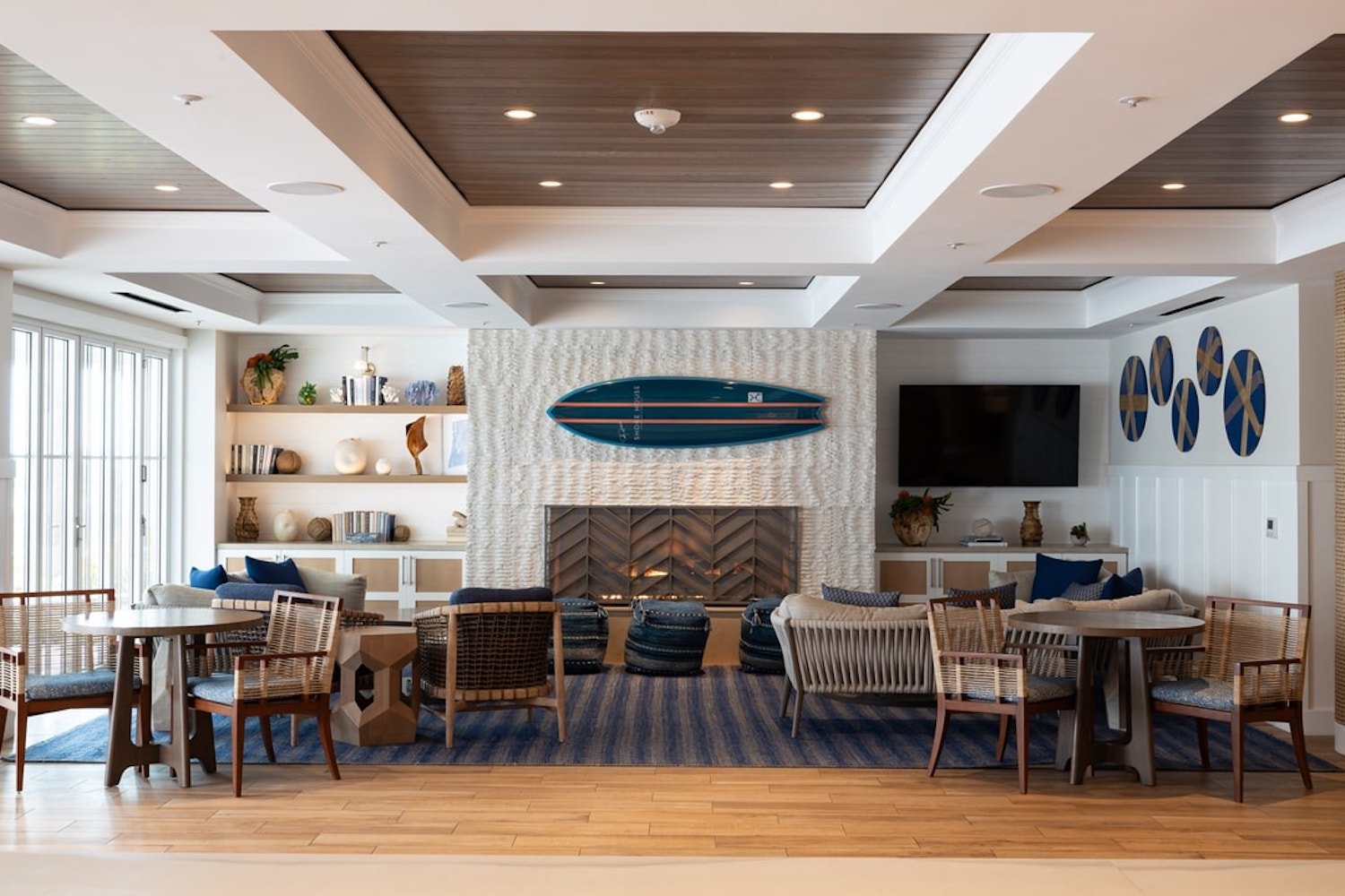 Interior of the Hotel Del Coronado's Shore House featuring a surfboard on the wall following a $550 million renovation project