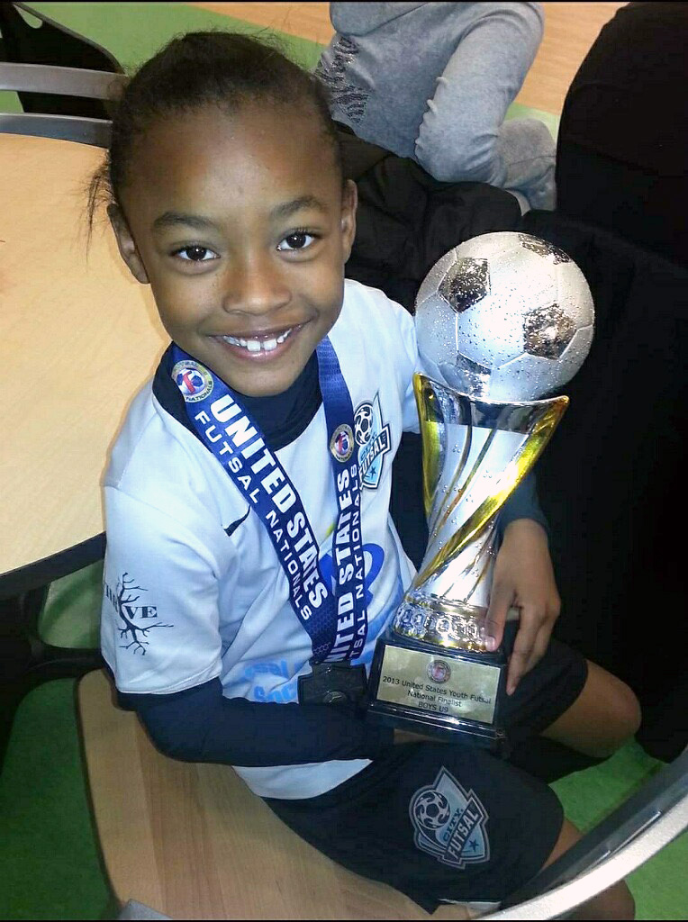 San Diego soccer player Jaedyn Shaw  who has been selected for the 2024 Paris Olympics as a kid with a trophy