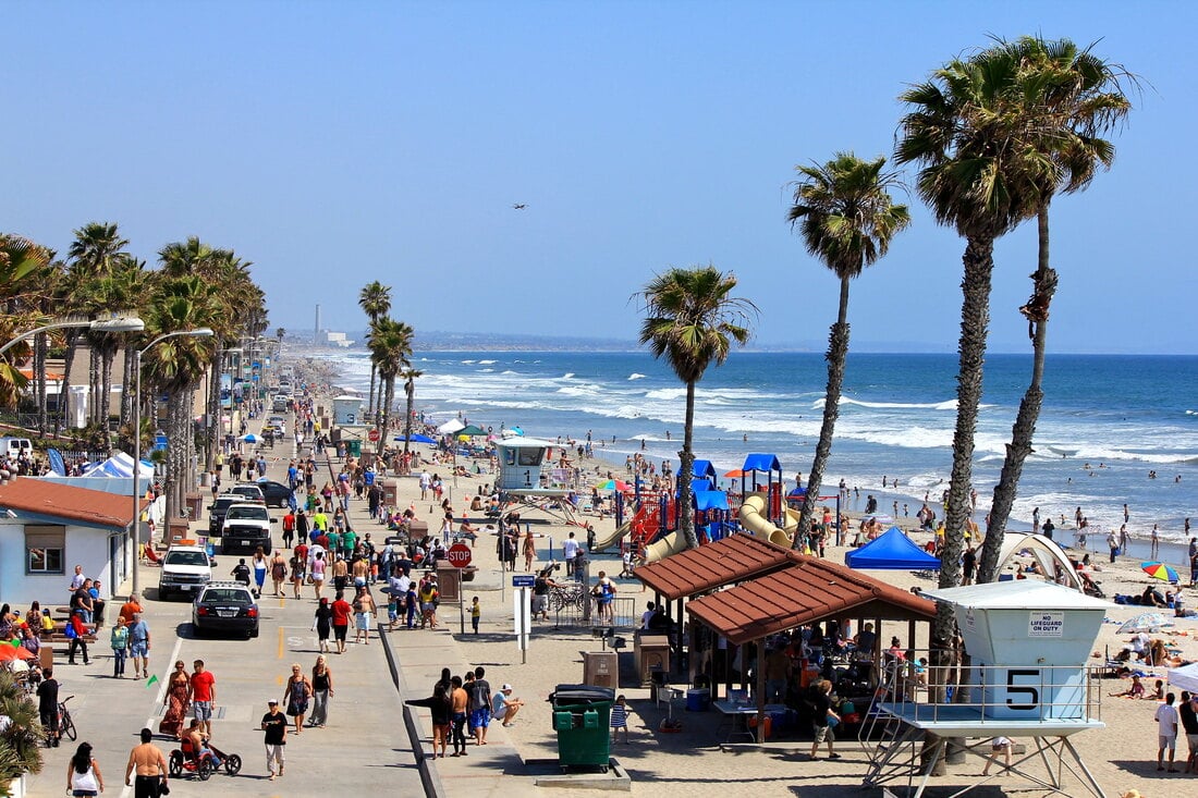 San Diego's Oceanside boardwalk full of people during the summer