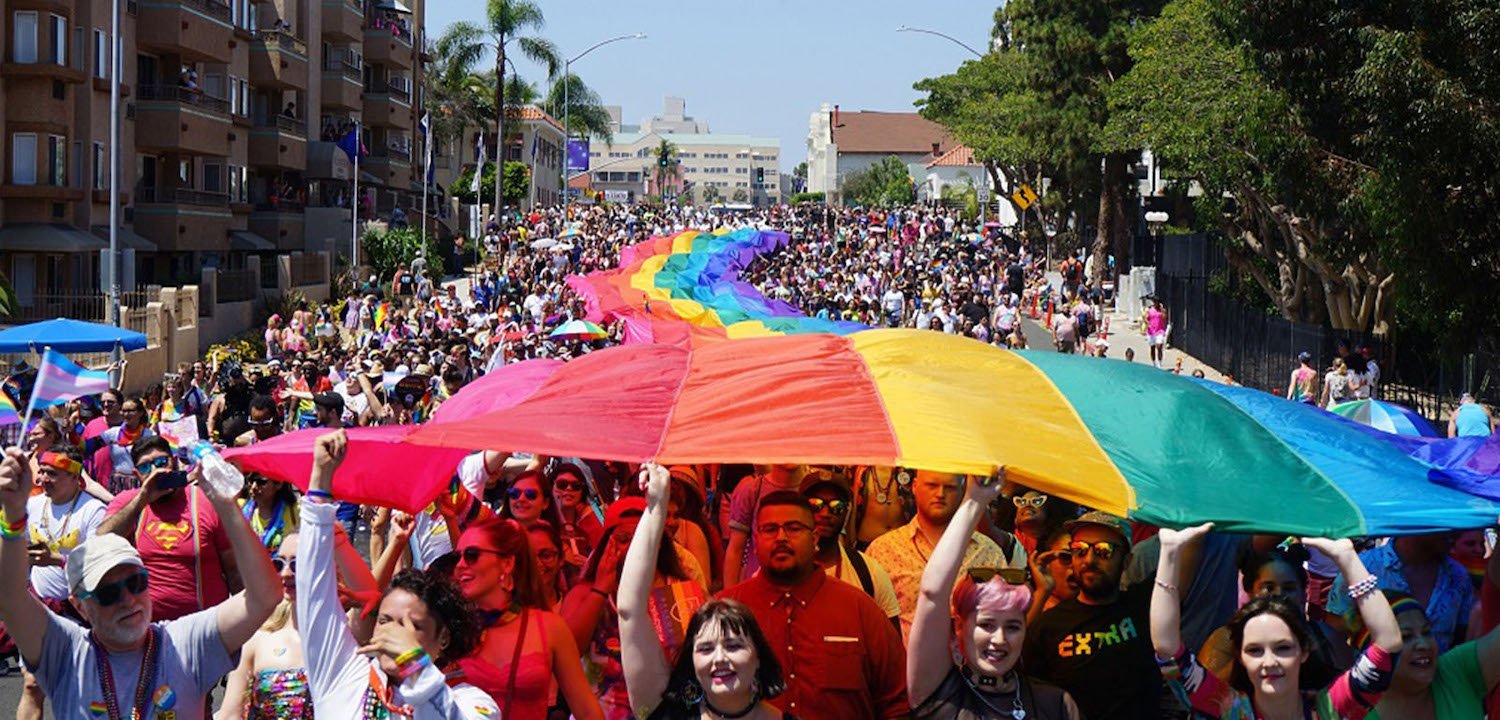2024 San Diego Pride Parade in Hillcrest near Balboa Park featuring a LGBTQ flag banner