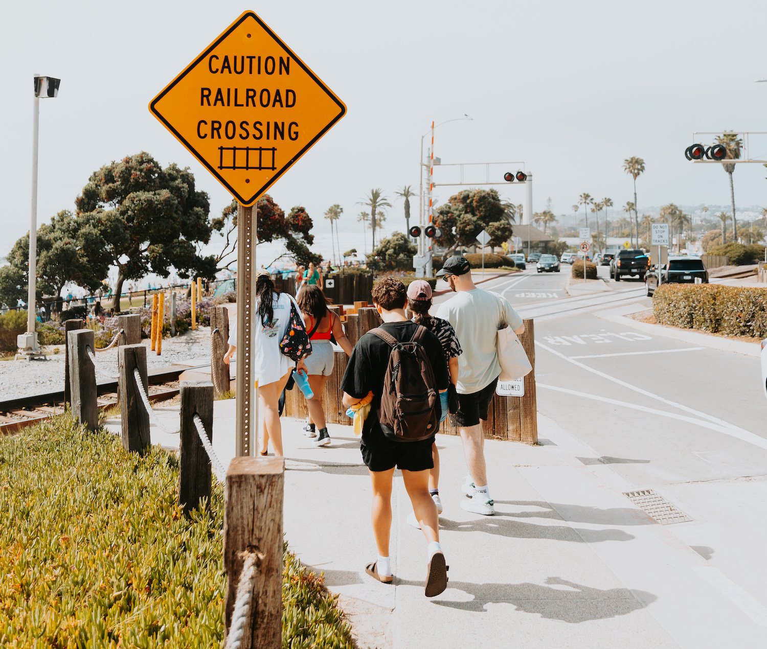 People walking to the beach in Del Mar, San Diego and crossing railroad tracks