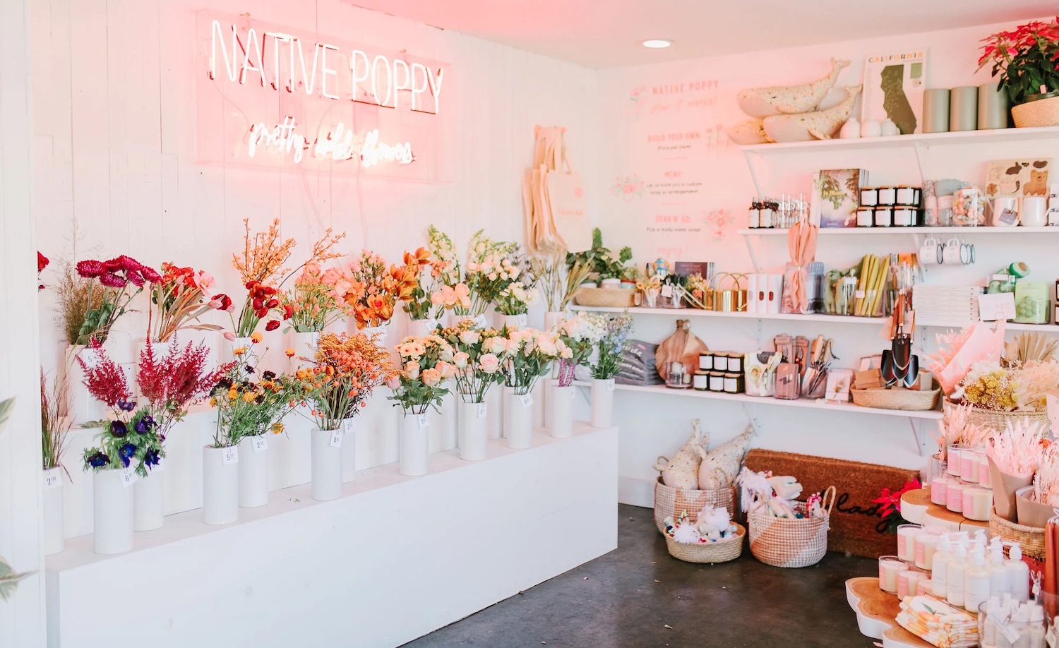 Interior of San Diego boutique flower shop Native Poppy in South Park featuring florals, a neon sign, and home decor