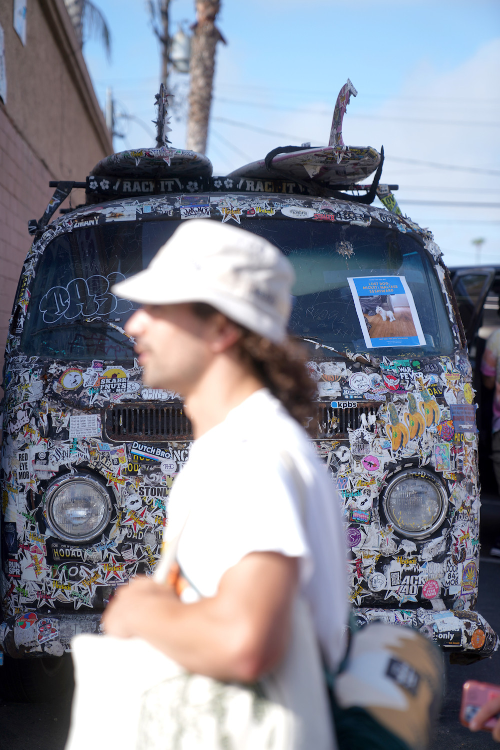 Ocean Beach resident walking past a Volkswagon van covered in stickers