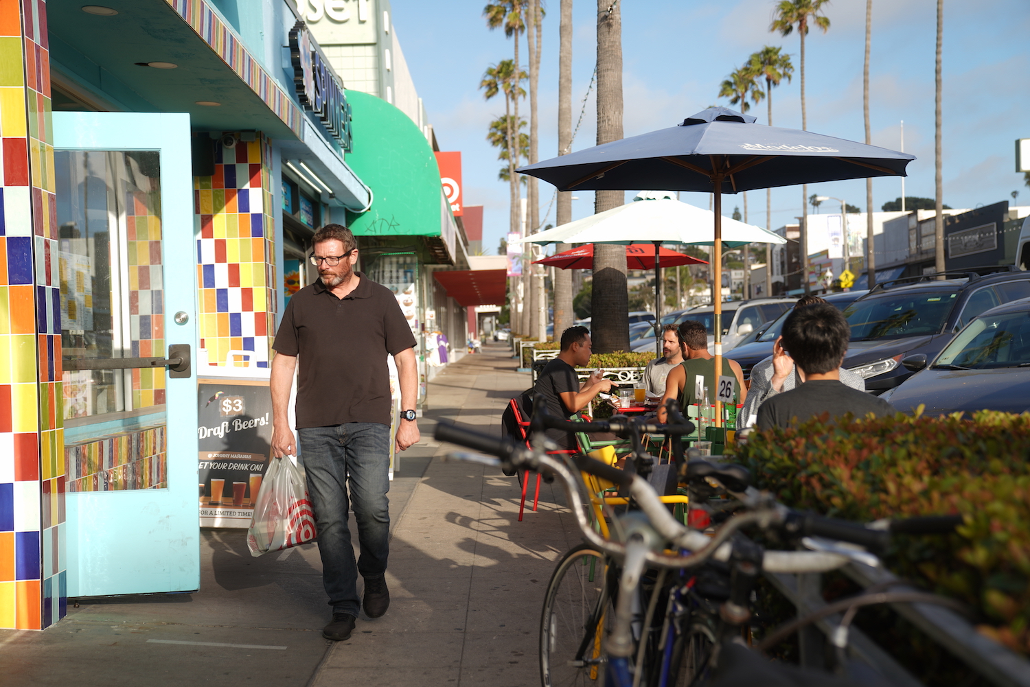 Ocean Beach, San Diego resident walking past shops on Newport Avenue 